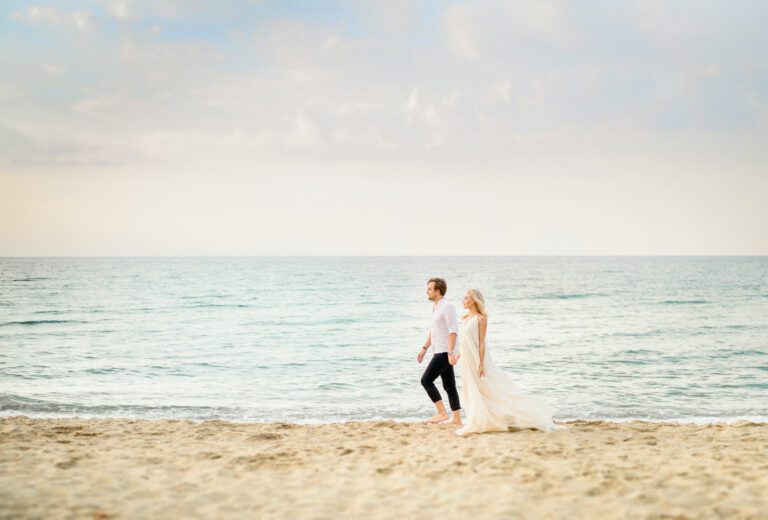 Beautiful stylish couple posing on the beach